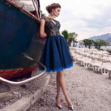 Load image into Gallery viewer, Traugel Illusion Scoop A Line Short Cocktail Dresses Applique Seqiuns 3D Flower Cap Sleeve Backless Mini Prom Evening Party Gown